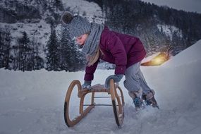 girl with big sleds in the snow