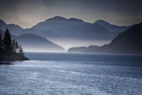 haze over the lake near the mountains