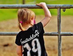 curious baby by the fence