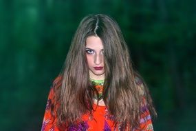 woman with long hair in the evening forest