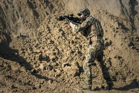 military man with a weapon takes aim