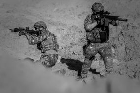 soldiers with guns in the desert