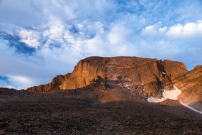 white clouds over picturesque mountainous terrain