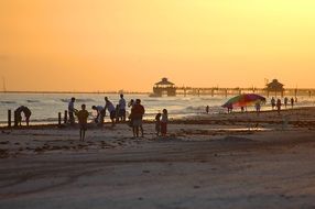 tourists on the beach at Fort Myers Beach at sunset, Florida