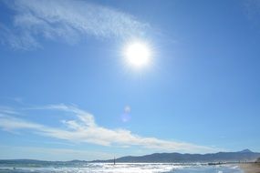 blue sky and bright sun over a beach in Mallorca