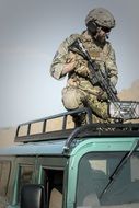 military with weapons on cars