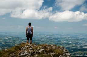 man stands on top of a rocky mountain