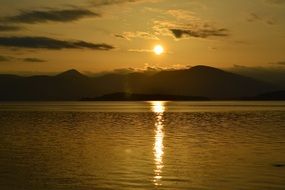 landscape of sun at sunset over a lake in scotland