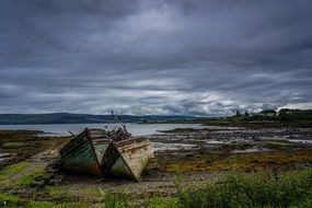 old boats on the coastline on a cloudy day