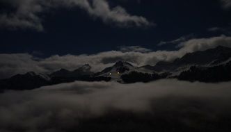 white clouds over the alps at night