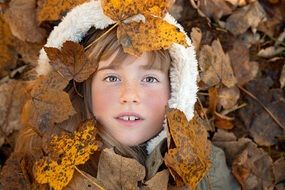 child among the autumn foliage