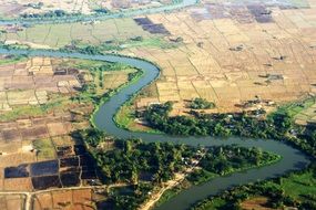 aerial view of winding river in farmland, Myanmar, Yangon