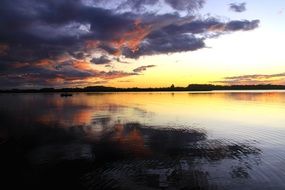 Peaceful landscape with Golden evening sky and colorful Clouds above calm water