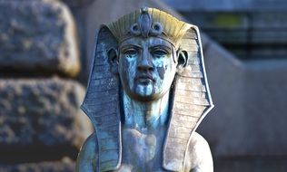 weathered sphinx statue in heidelberg on a blurred background