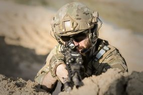 aiming soldier close-up on blurred background