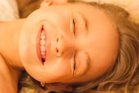 girl's smile close-up on blurred background