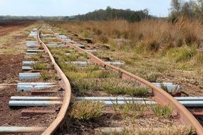 old rusty railway rails in the grass