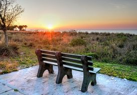 bench on the coast at sunset