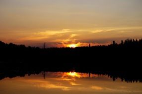 fiery sunset over the black forest on the lake