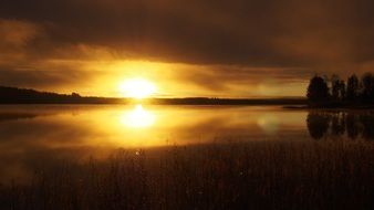 yellow sunrise over the water on the horizon
