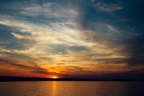 serene sunset on the lake on the horizon