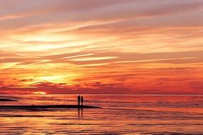couple in love near the north sea at sunset