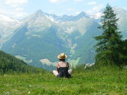 tourist girl admiring mountains on a sunny day