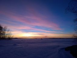pink sunset over a snowy lake