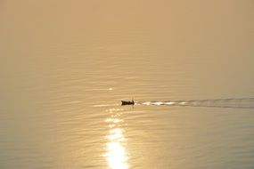 lonely boat in the sea at sunset