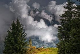 mountain peaks among clouds in picturesque Alpine Landscape