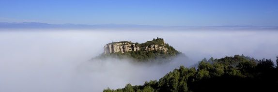 landscape of high green rock in the fog