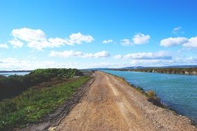 soil Road at River, summer rural landscape