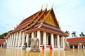 monks in orange costumes at a Buddhist temple