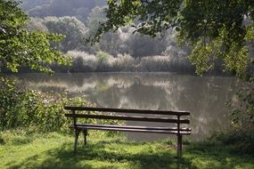 bench near the river among idyllic landscape