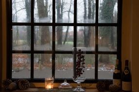 vase and candle at lattice Window, still life