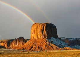 rainbow over the mountains in the snow