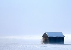 house on the field with snow