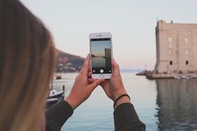 girl photographs a port in Dubrovnik, Croatia