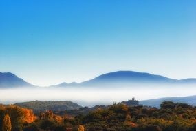 white fog over the mountains in the fall