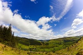 sky with white clouds over a valley in a national park
