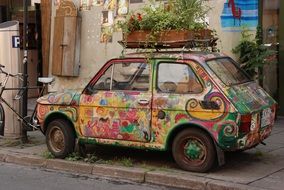 box with flowers on an old multi-colored car