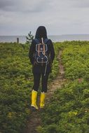 hiker with backpack and yellow rubber boots