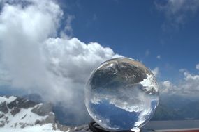 glass ball on cloudy sky background