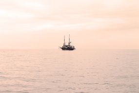yacht in the sea against the pink sky