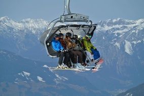 people on ski lift over mountains, austria, zillertal arena