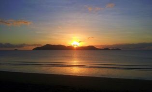 setting sun over mountains