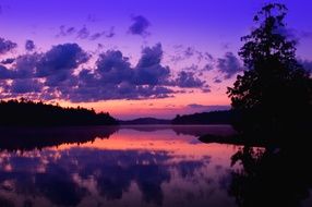 purple sky with clouds over the lake during sunset