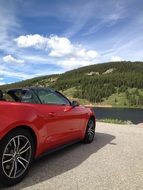 Red Convertible car and hill