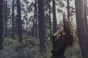 Girl in the black dress in the forest