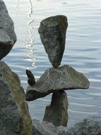 tower of stones on the background of water